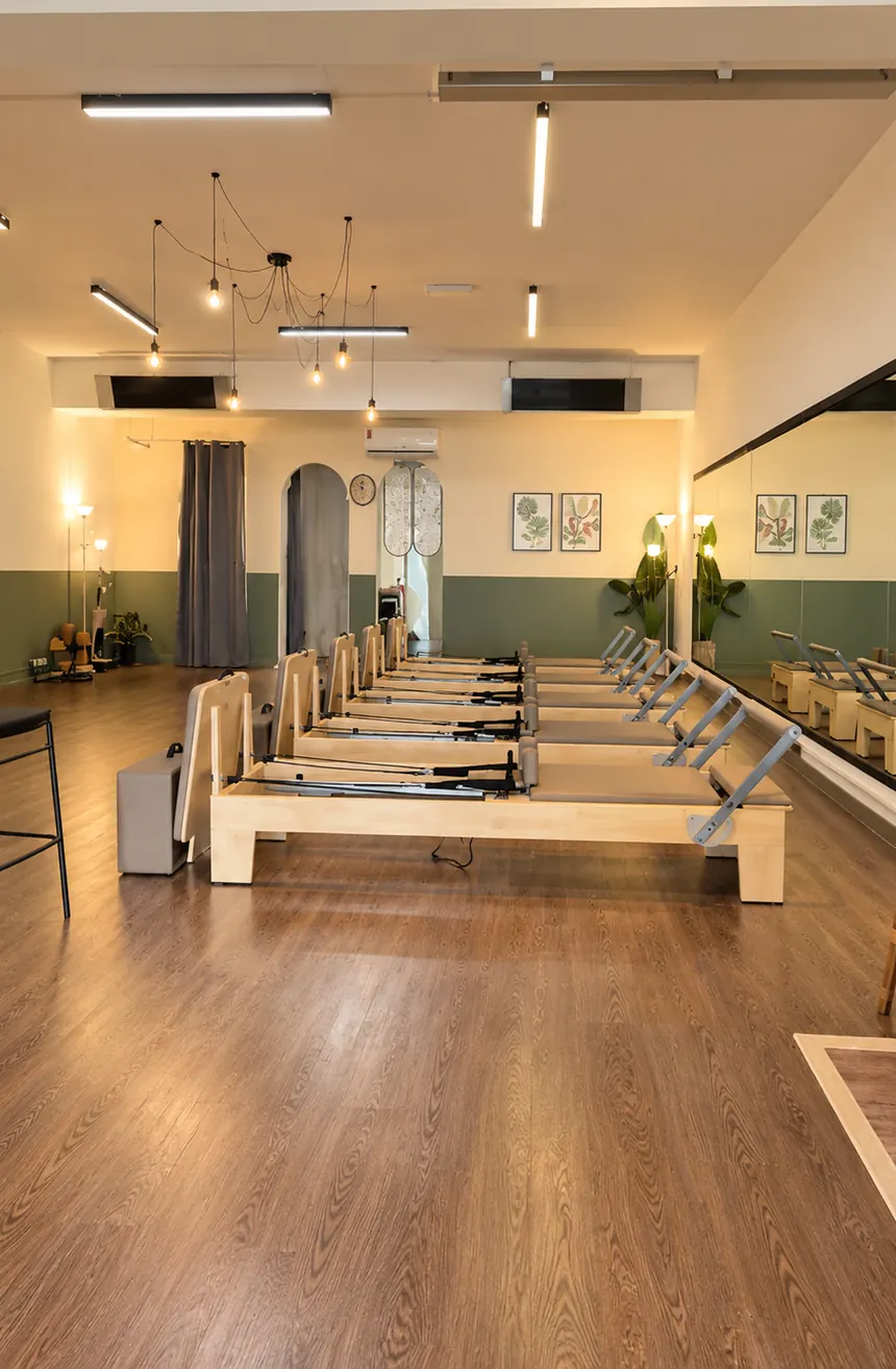 The long main studio under warm pendant lights